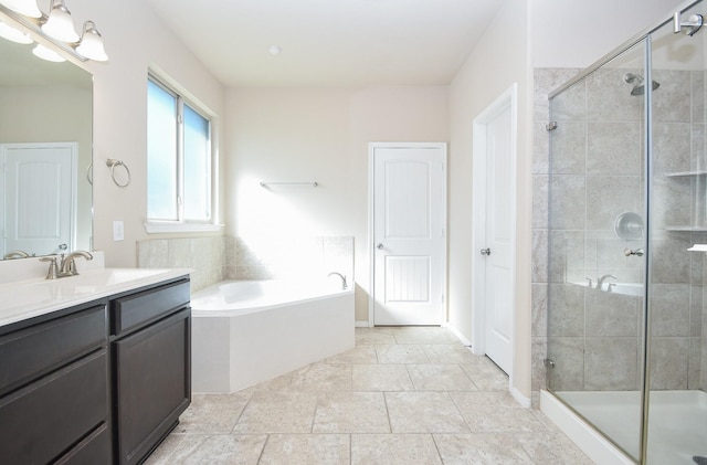 bathroom with plus walk in shower, tile patterned flooring, and vanity