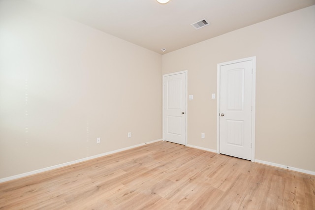 spare room featuring light hardwood / wood-style flooring