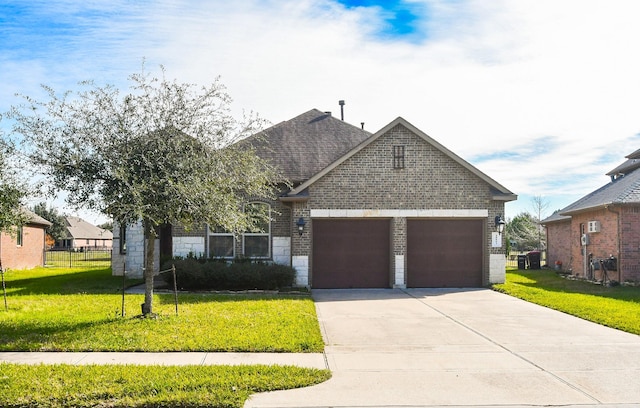 view of front of home with a garage and a front lawn