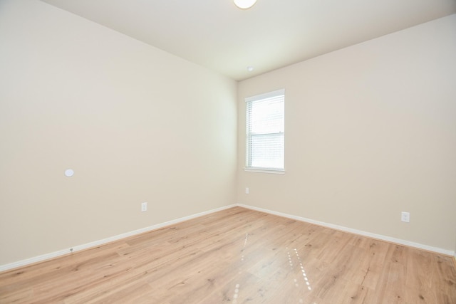 spare room featuring light wood-type flooring