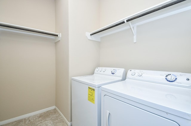 clothes washing area with washing machine and clothes dryer