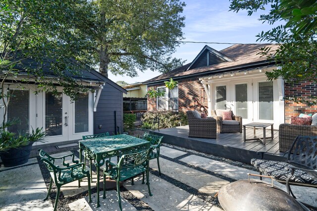 view of patio / terrace featuring a wooden deck and french doors