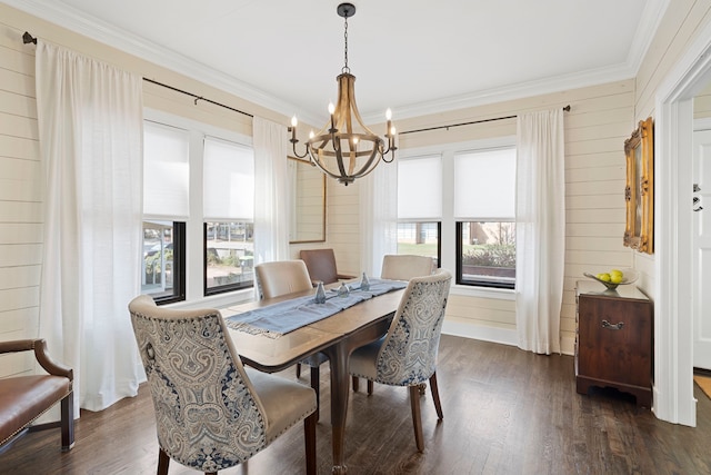 dining area with ornamental molding, dark hardwood / wood-style floors, a wealth of natural light, and a notable chandelier