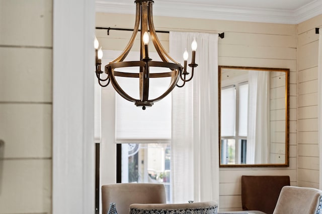 details featuring wood walls, ornamental molding, and a chandelier