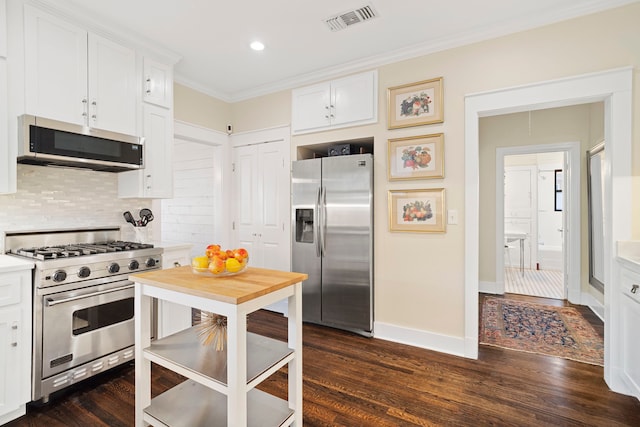 kitchen featuring dark hardwood / wood-style flooring, white cabinetry, and stainless steel appliances