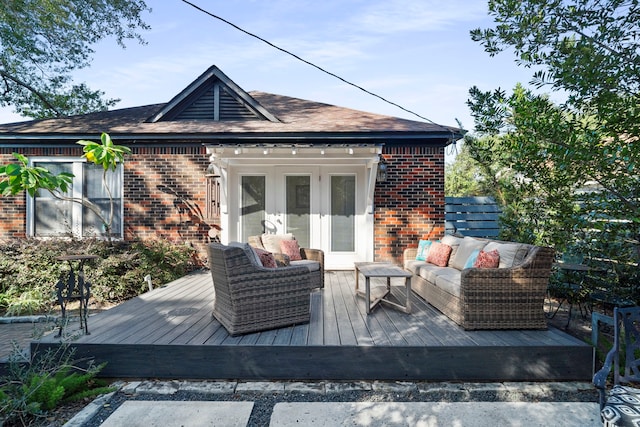 deck featuring an outdoor living space and french doors