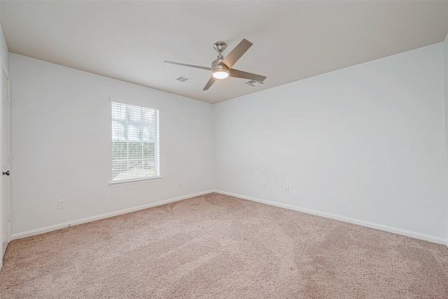 carpeted spare room featuring ceiling fan