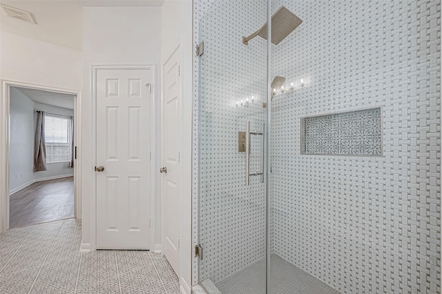 bathroom with tile patterned flooring and a shower with door