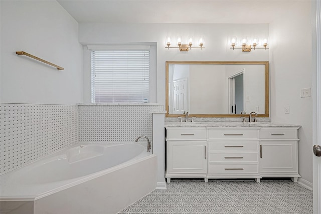 bathroom with tile patterned flooring, vanity, and a tub