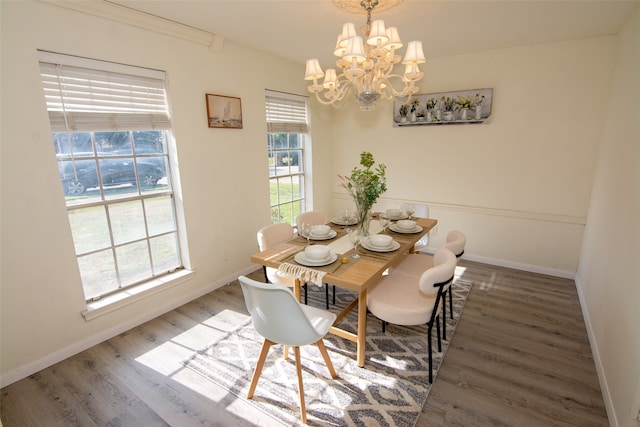 dining area featuring a notable chandelier and dark wood-type flooring