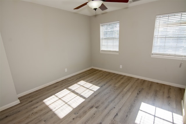 spare room with light hardwood / wood-style flooring and ceiling fan