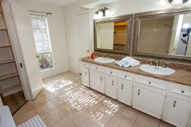 bathroom with tile patterned floors, vanity, and a shower