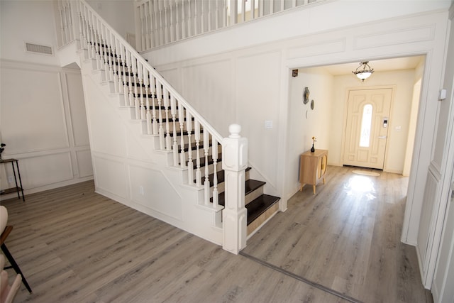 entryway with hardwood / wood-style flooring and a high ceiling