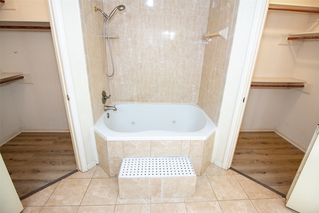 bathroom featuring wood-type flooring and tiled shower / bath combo