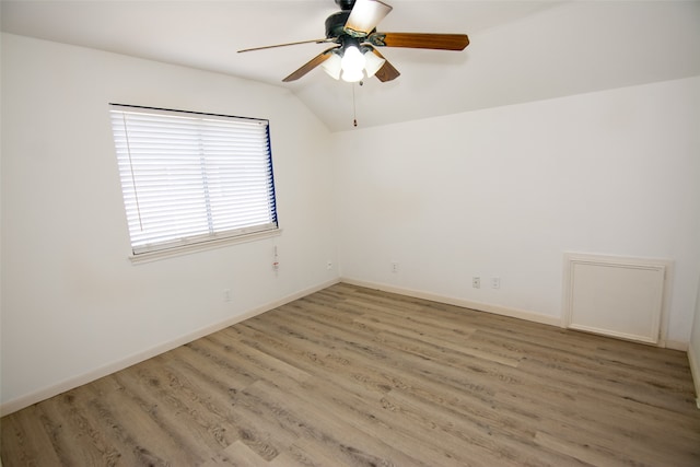 spare room featuring ceiling fan, lofted ceiling, and hardwood / wood-style flooring