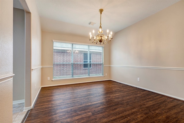 unfurnished dining area featuring vaulted ceiling, wood-type flooring, and an inviting chandelier