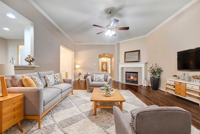 living room with hardwood / wood-style flooring, ceiling fan, and ornamental molding