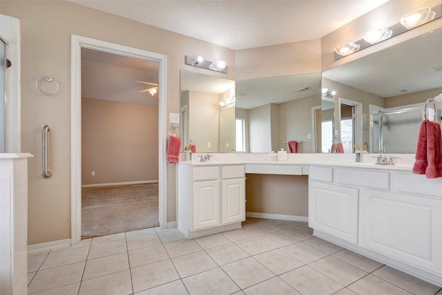 bathroom with tile patterned flooring, vanity, and a shower with door