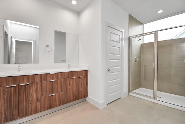 bathroom with tile patterned flooring, vanity, and walk in shower