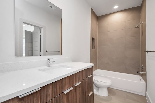 full bathroom with vanity, tiled shower / bath combo, and toilet