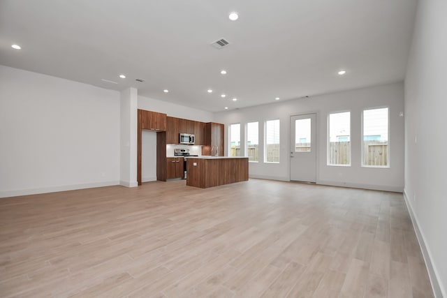 kitchen featuring a center island, light hardwood / wood-style flooring, and sink