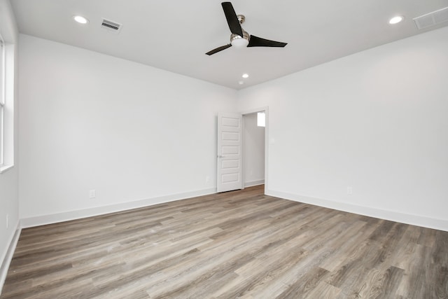 empty room with light wood-type flooring and ceiling fan