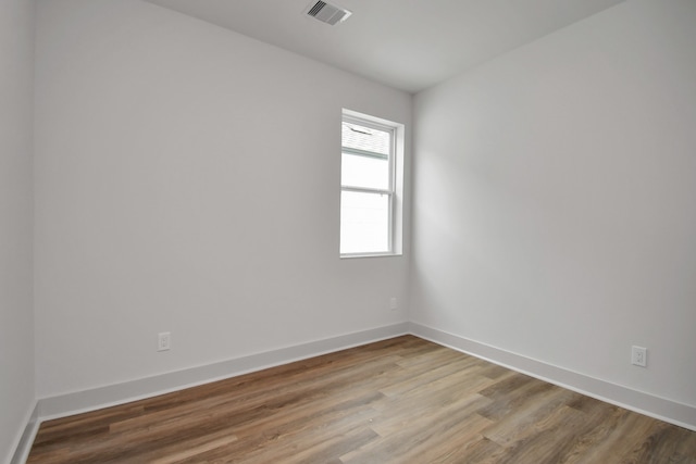 unfurnished room with hardwood / wood-style flooring