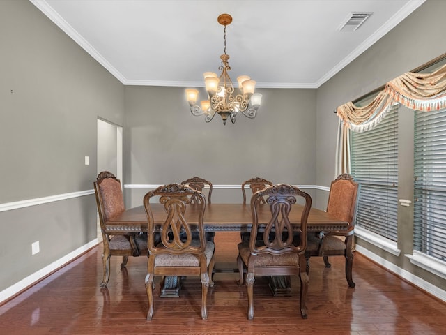 dining space with a chandelier, dark hardwood / wood-style floors, and ornamental molding