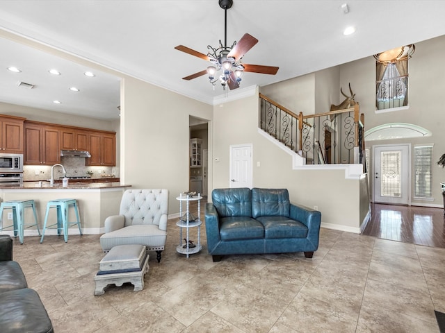 living room featuring ceiling fan and ornamental molding