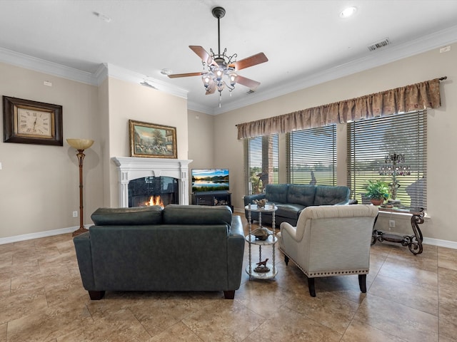 living room with crown molding, ceiling fan, and a healthy amount of sunlight