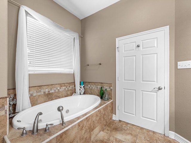 bathroom featuring tile patterned flooring and tiled tub