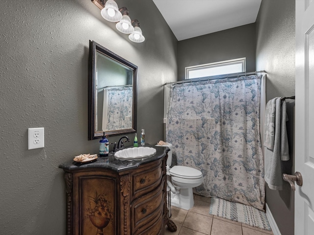 bathroom featuring tile patterned floors, vanity, toilet, and walk in shower