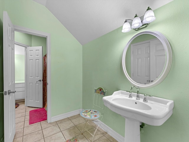 bathroom featuring tile patterned flooring and vaulted ceiling