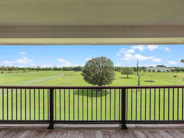 deck featuring a rural view and a yard