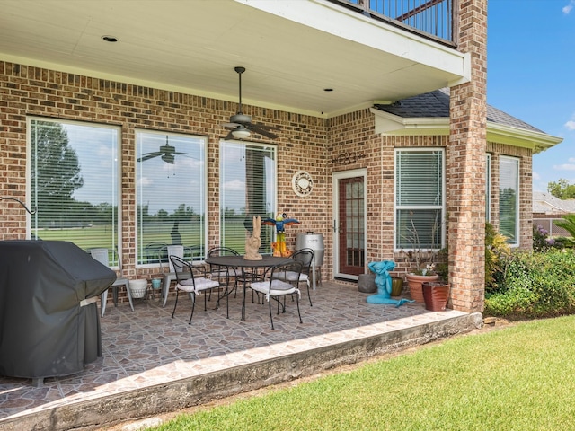 view of patio / terrace featuring ceiling fan, area for grilling, and a balcony