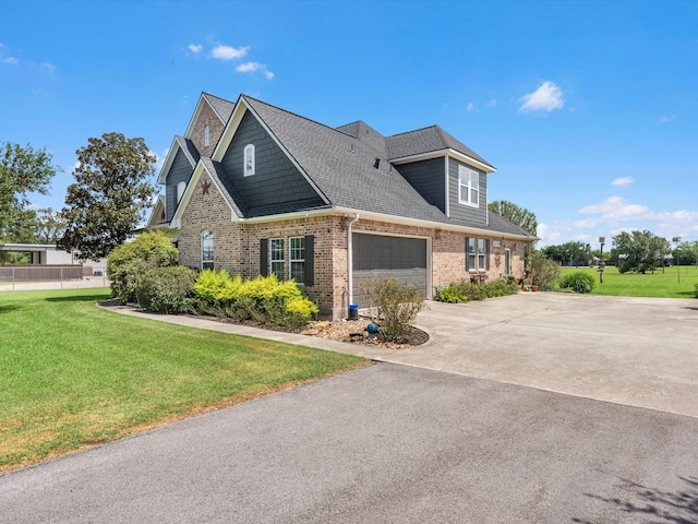 view of front of home featuring a garage and a front yard