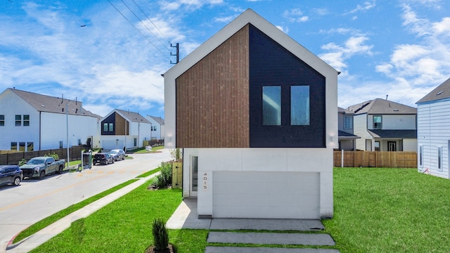 view of front of home featuring a front yard and a garage