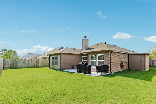 rear view of house with a patio area and a lawn