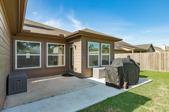 rear view of property with a lawn and a patio area