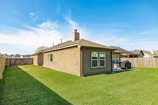 back of house with a lawn