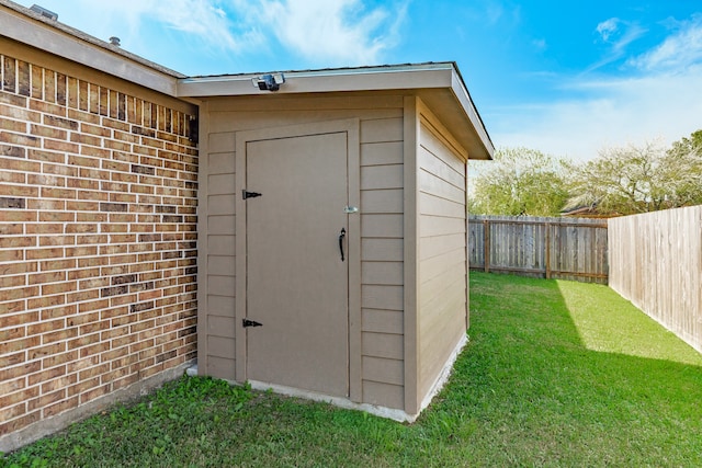 view of outbuilding with a lawn