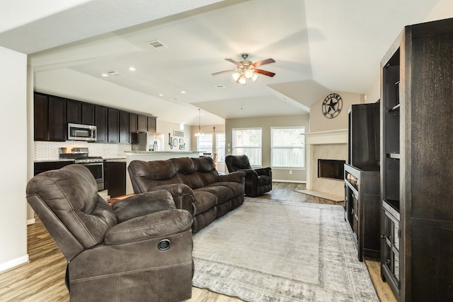 living room featuring light hardwood / wood-style flooring and vaulted ceiling