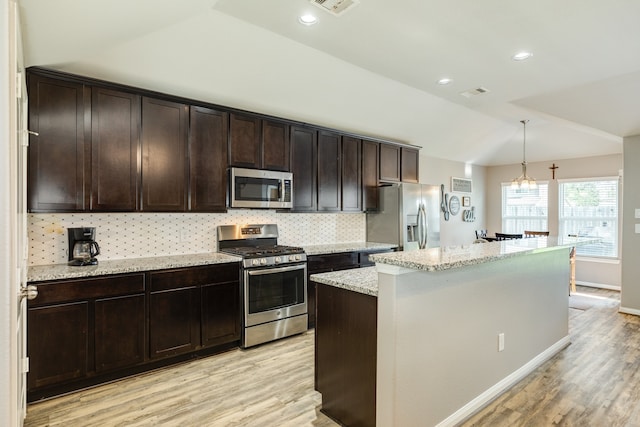 kitchen featuring pendant lighting, a center island, an inviting chandelier, light hardwood / wood-style flooring, and stainless steel appliances