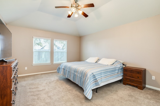 bedroom with light colored carpet, vaulted ceiling, and ceiling fan