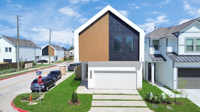 view of front of house featuring a garage and a front lawn