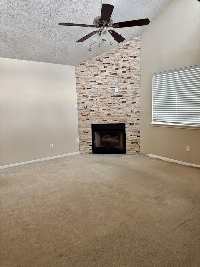 unfurnished living room featuring a fireplace, a textured ceiling, ceiling fan, and lofted ceiling