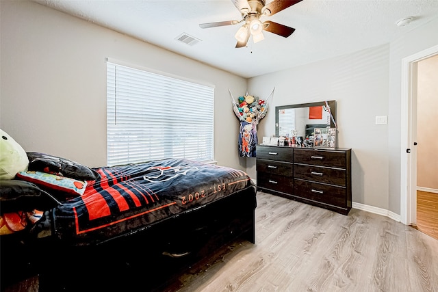 bedroom with light hardwood / wood-style flooring and ceiling fan