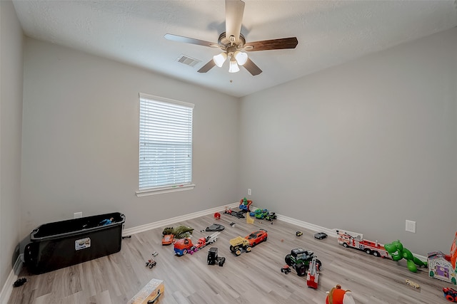 interior space with ceiling fan, hardwood / wood-style floors, and a textured ceiling