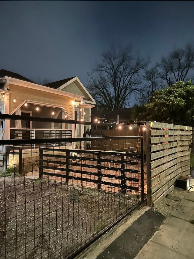 view of gate at twilight