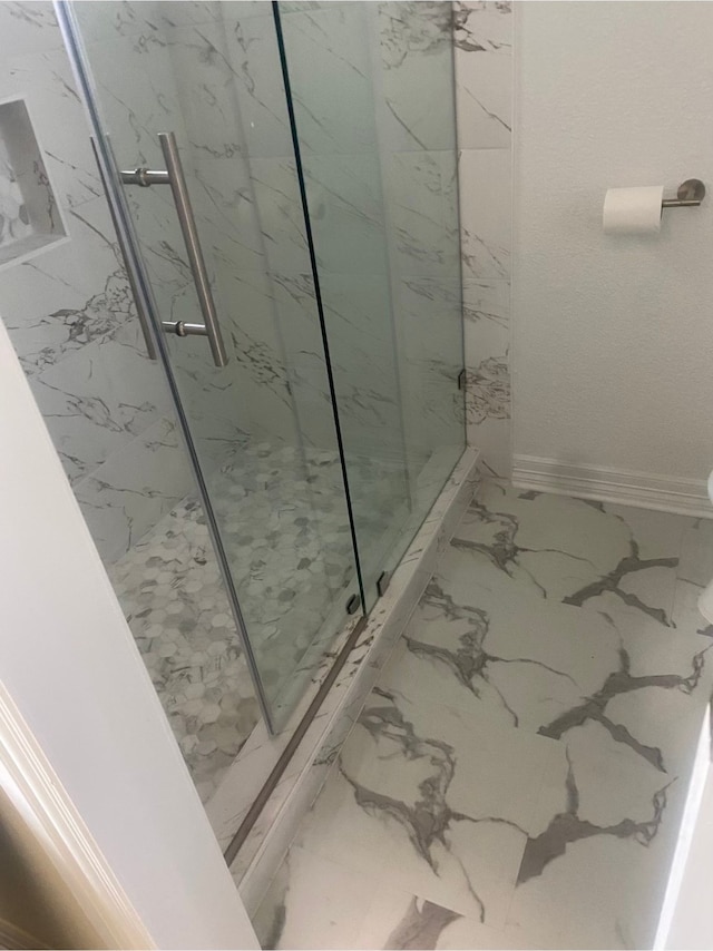 bathroom with a shower with shower door